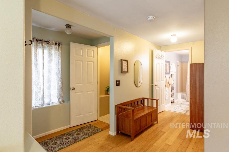 Hallway featuring light wood-style flooring