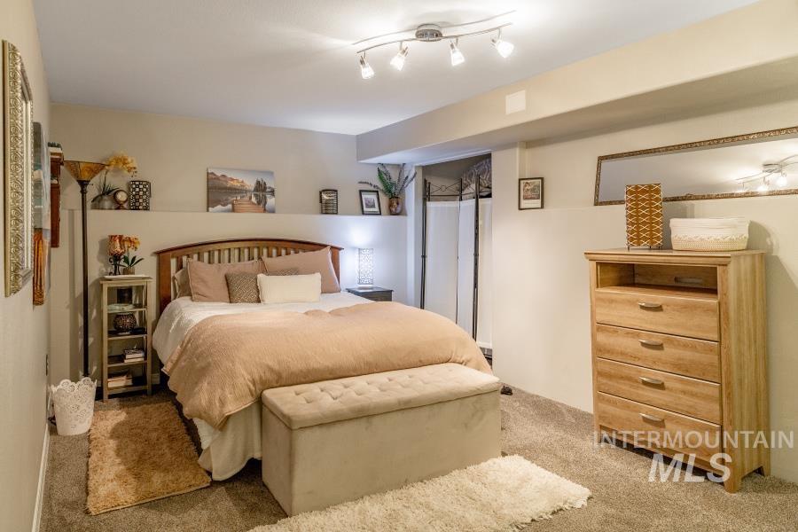 Bedroom featuring light colored carpet
