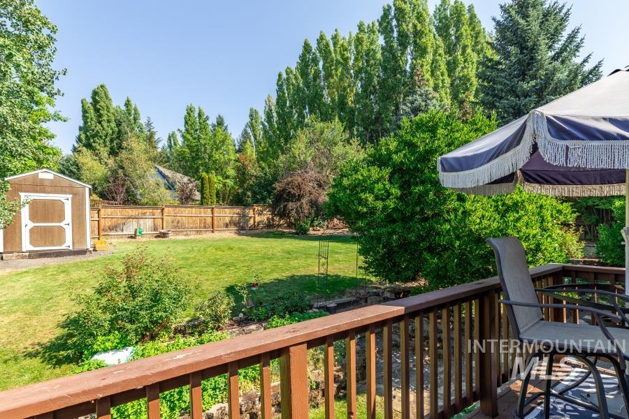 Fenced backyard featuring a shed