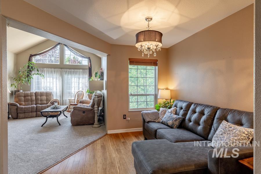 Living room featuring wood finished floors and a chandelier