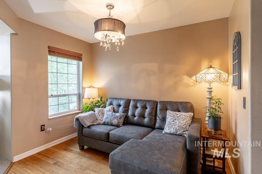 Living room with wood finished floors and a chandelier