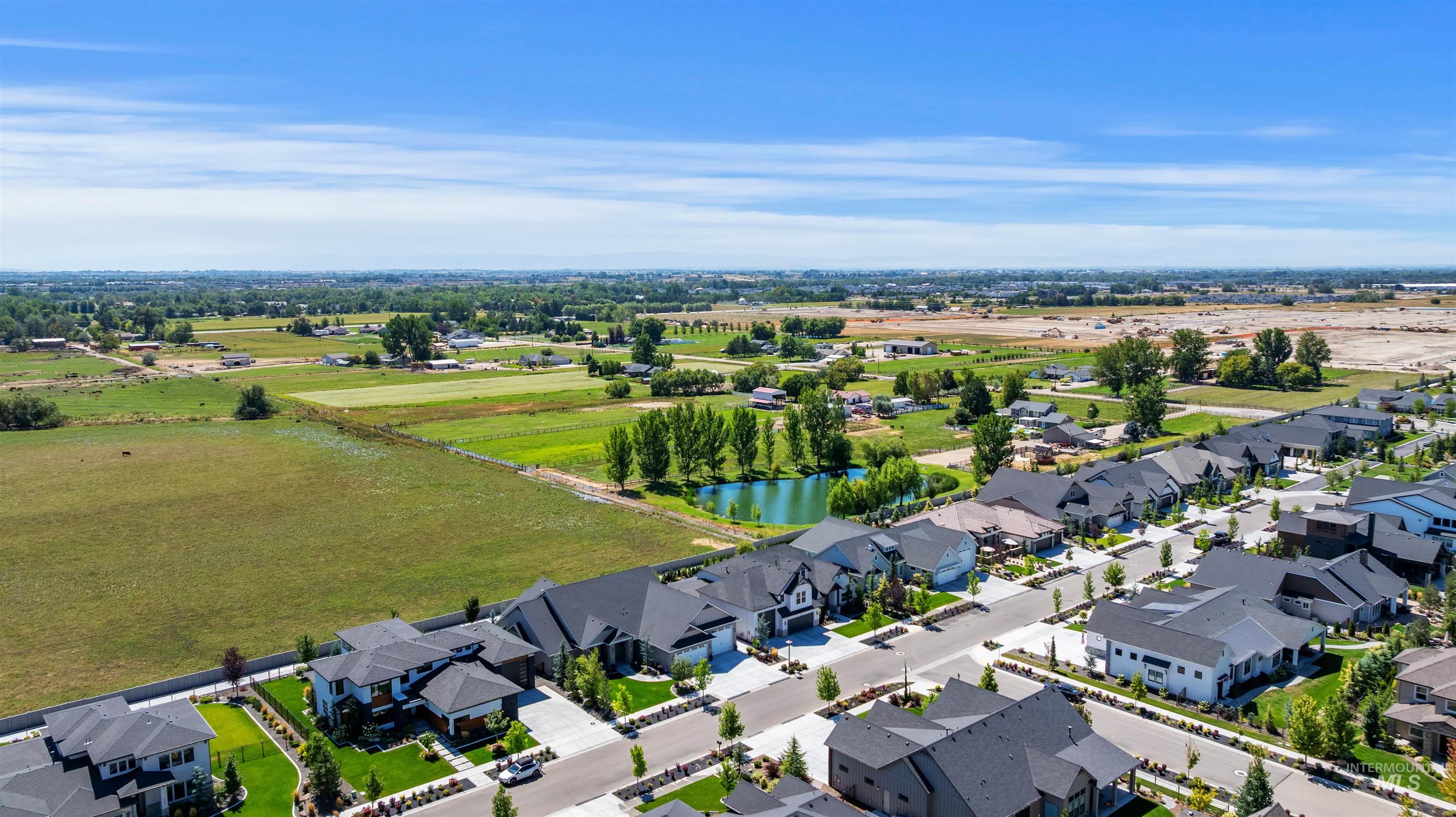 Aerial perspective of suburban area featuring a large body of water