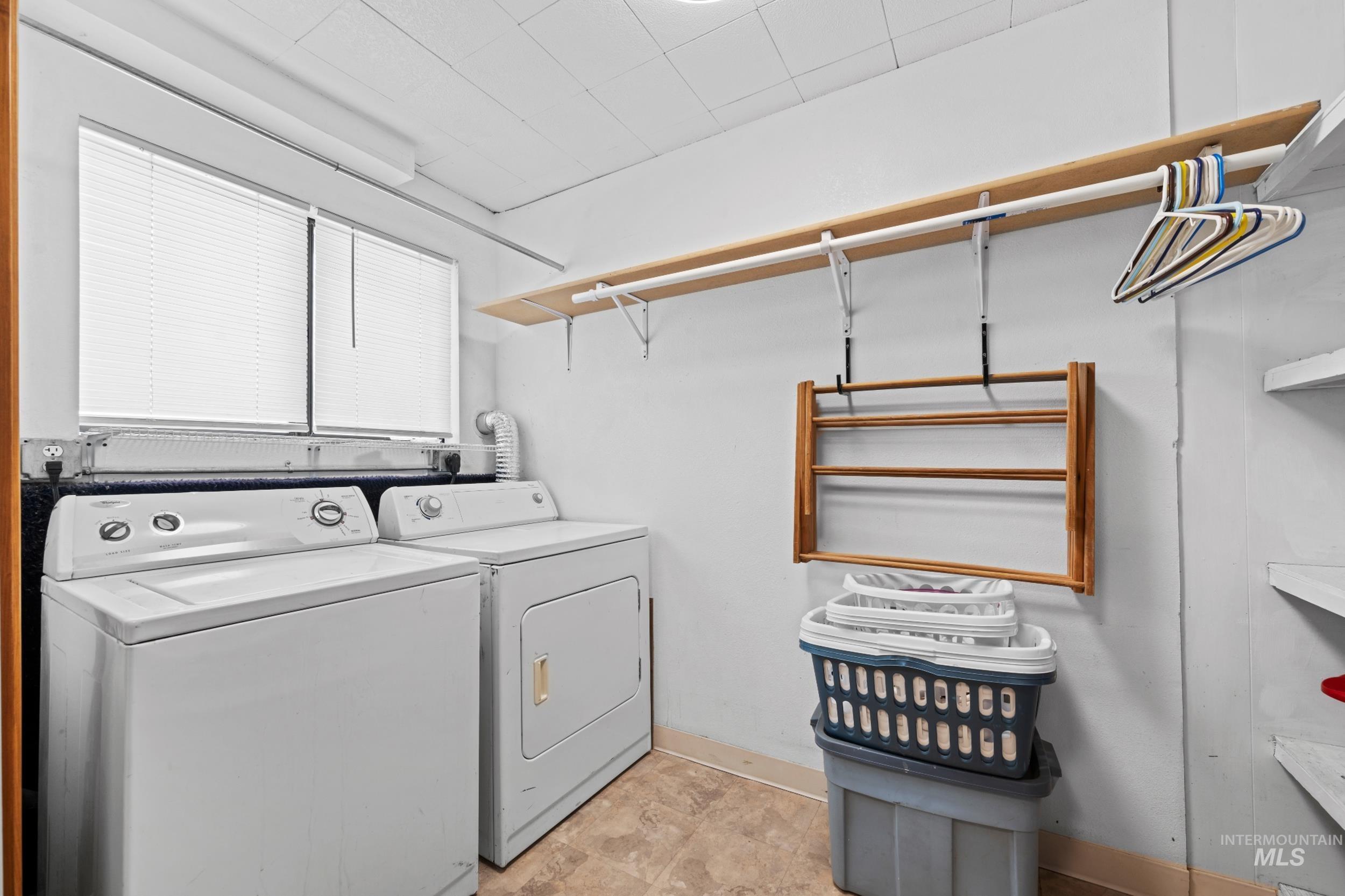 Laundry area featuring baseboards and separate washer and dryer