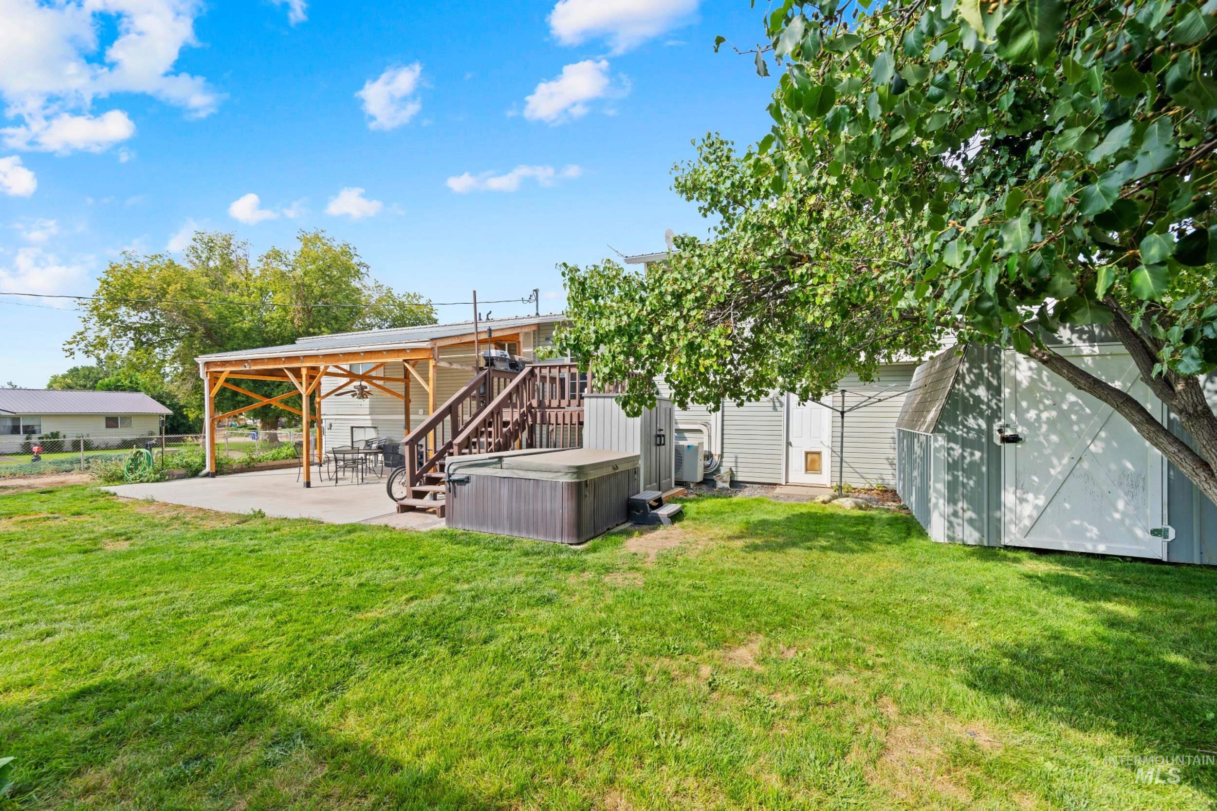 View of yard with a patio area, stairs, and an outdoor structure