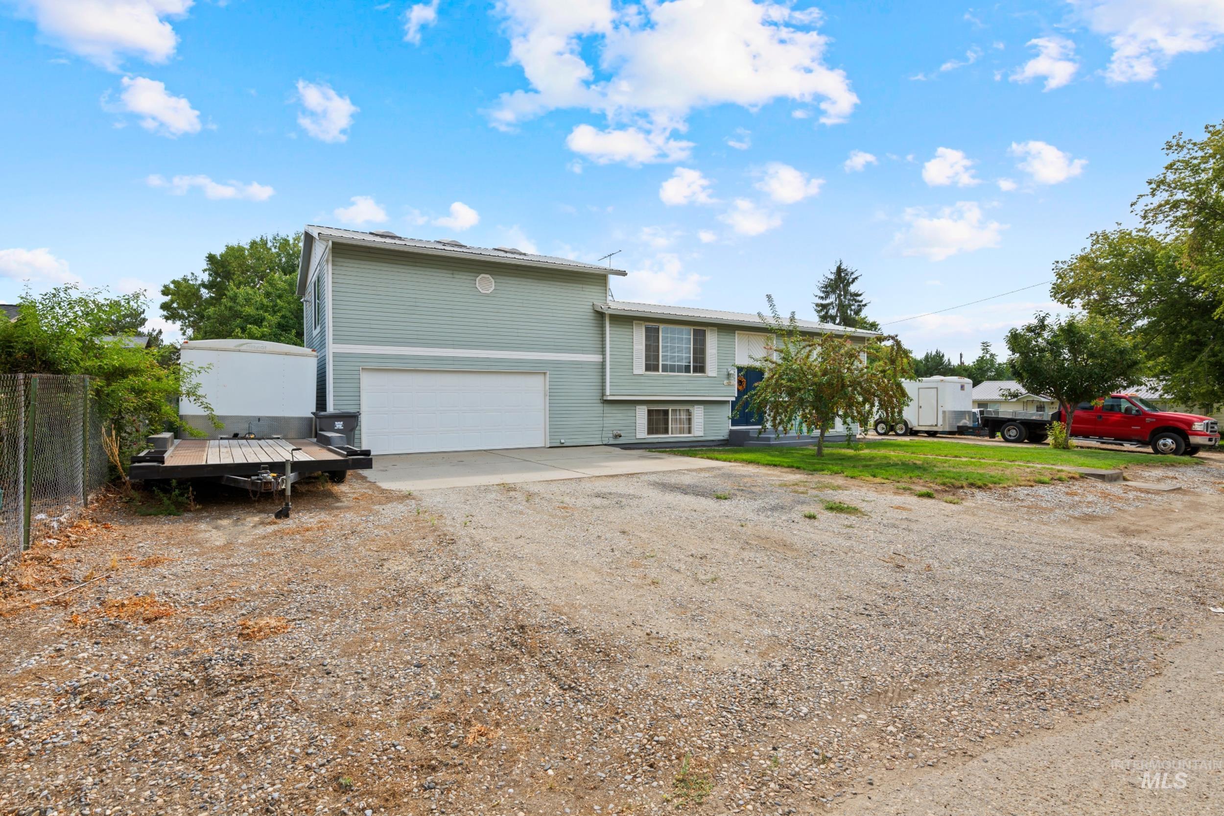 Split foyer home with driveway and a garage
