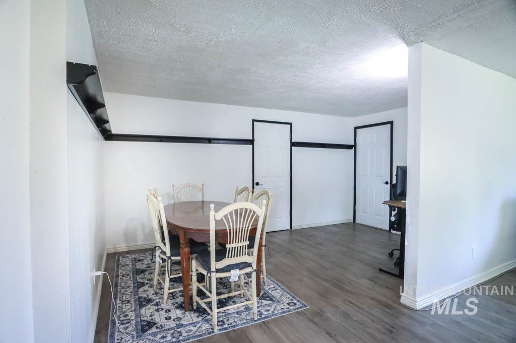 Dining space featuring wood finished floors and a textured ceiling