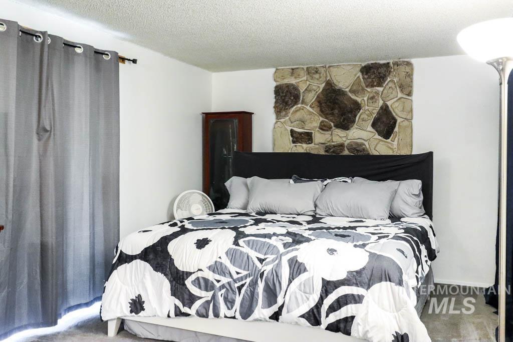 Bedroom featuring a textured ceiling and carpet floors