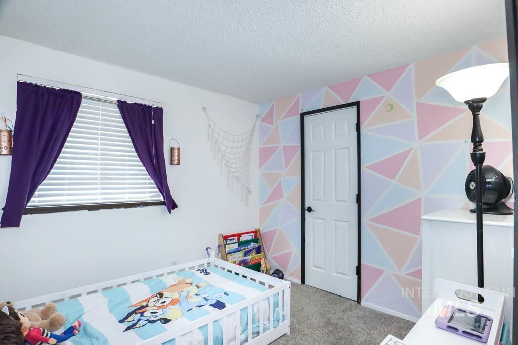 Bedroom with carpet floors and a textured ceiling