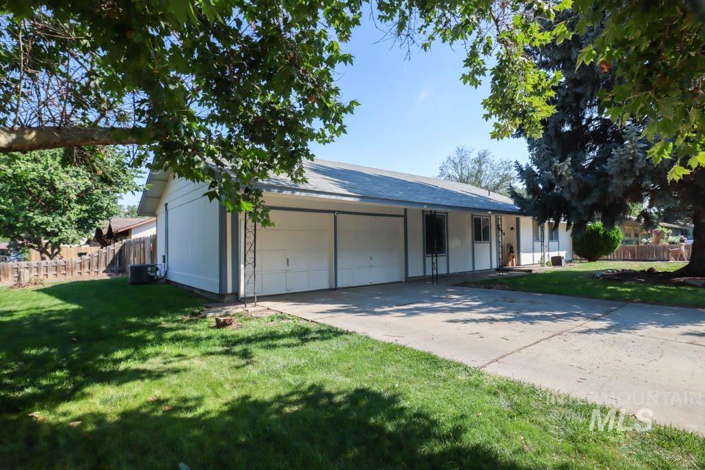 View of front facade featuring a garage and driveway