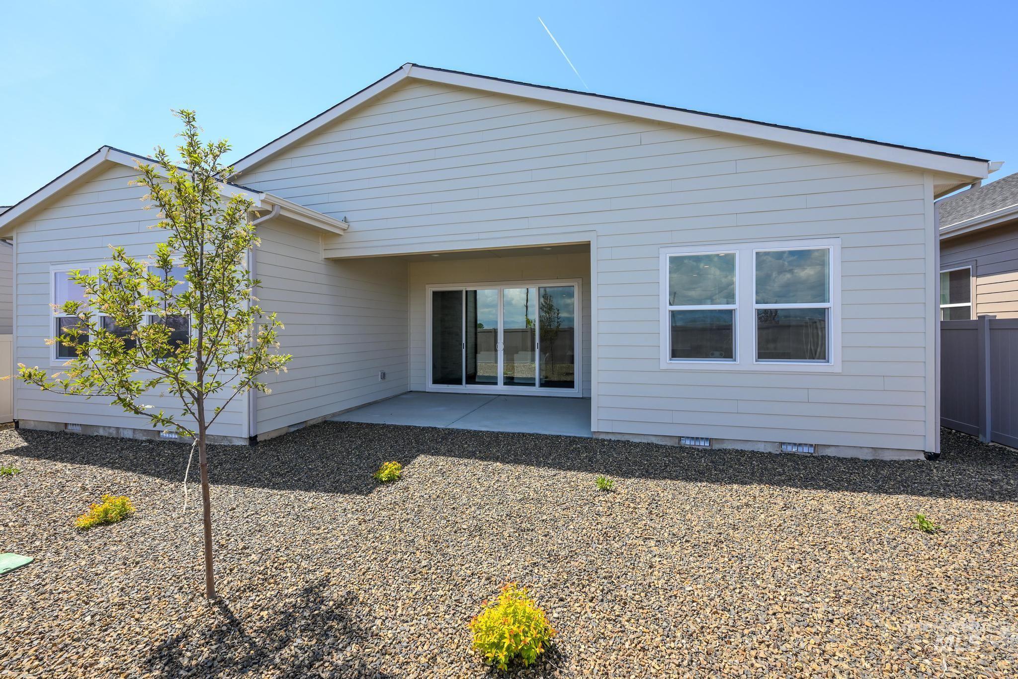 Back of property with crawl space and a patio