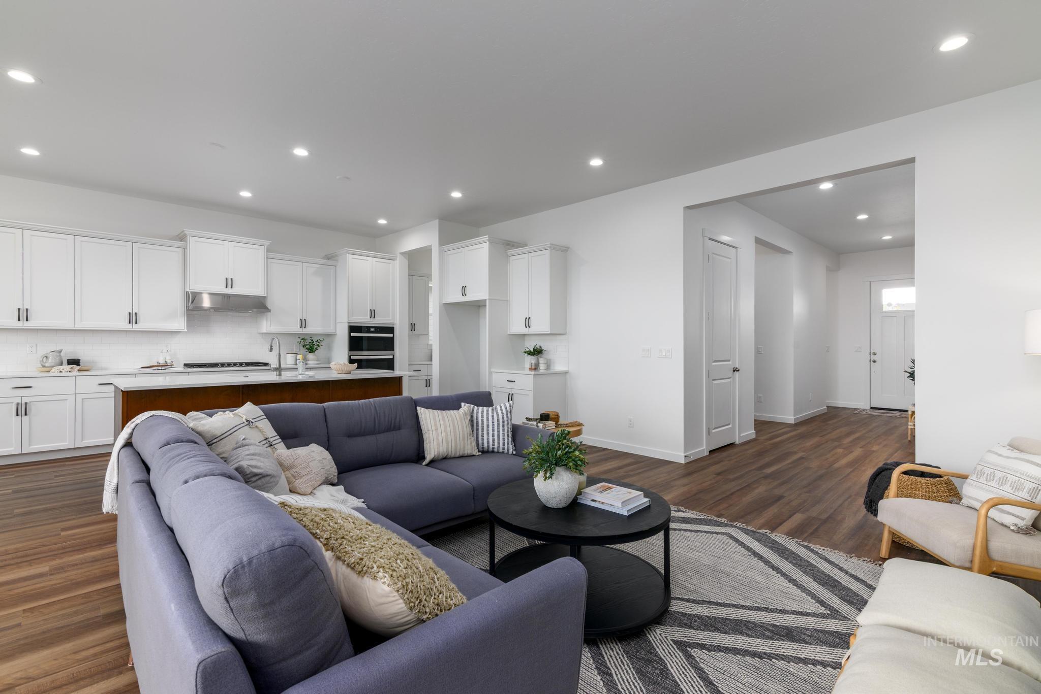 Living area featuring recessed lighting and dark wood-type flooring