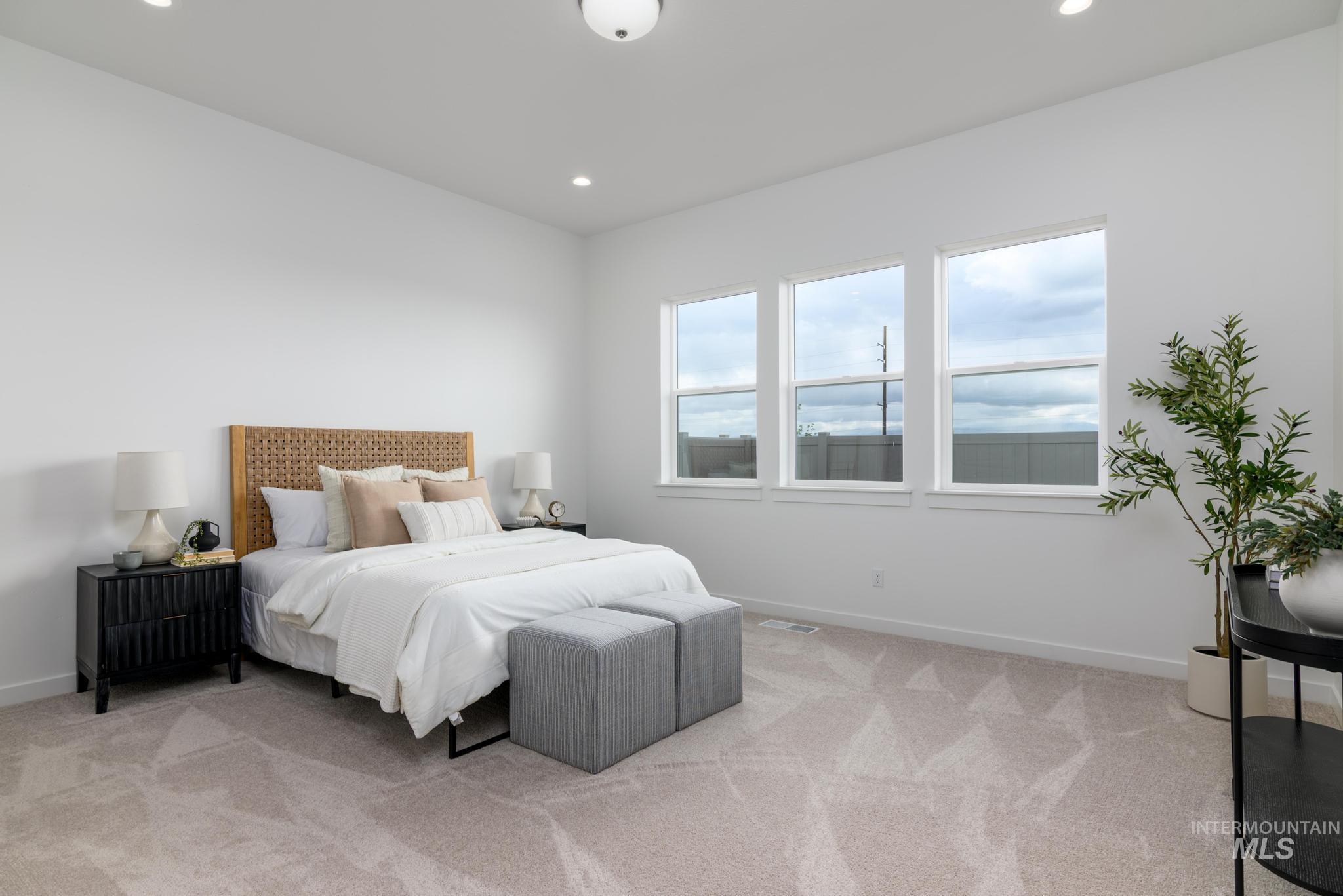 Bedroom featuring light colored carpet and recessed lighting