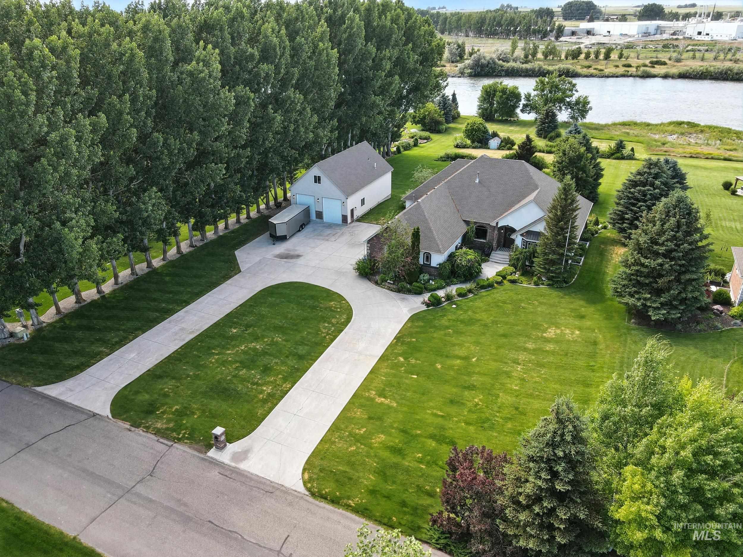 Aerial view of property and surrounding area featuring a large body of water