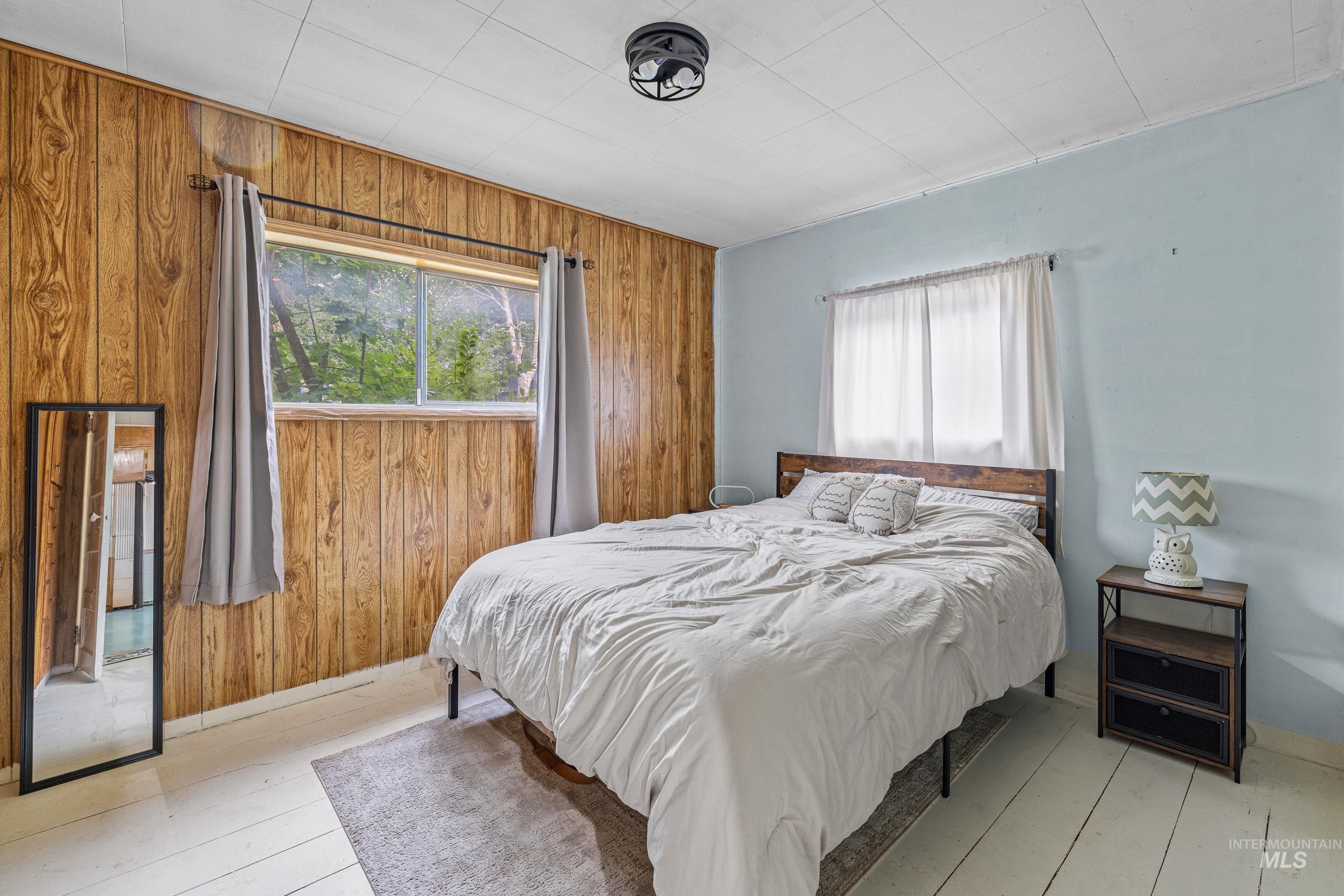 Bedroom with wood walls