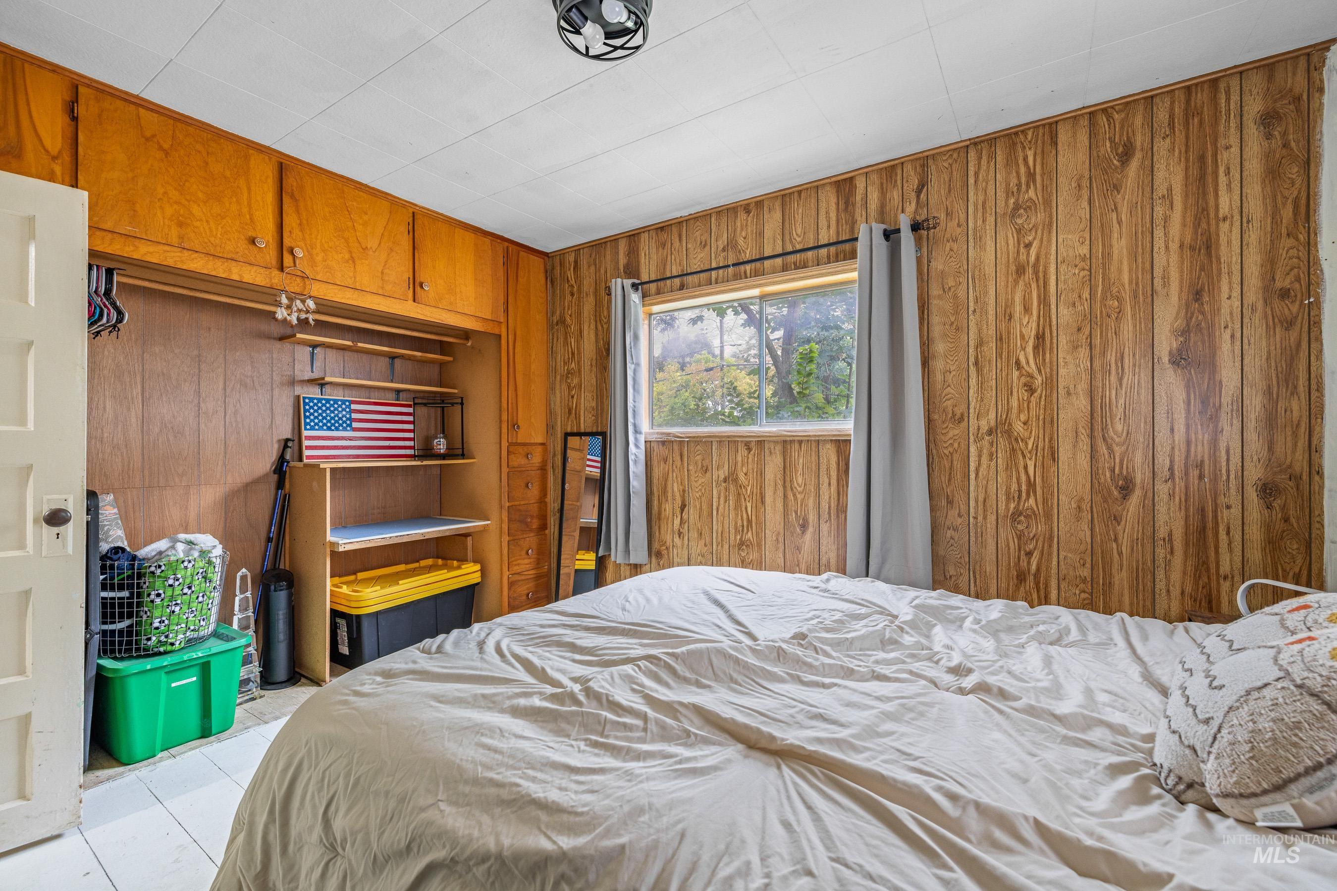 Tiled bedroom with wooden walls