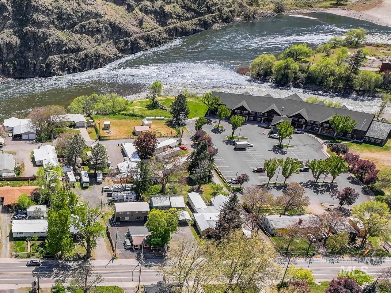 Aerial view of property and surrounding area featuring a large body of water