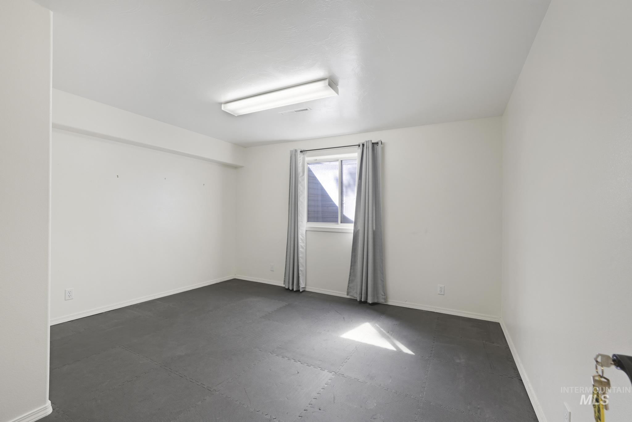Unfurnished room with baseboards