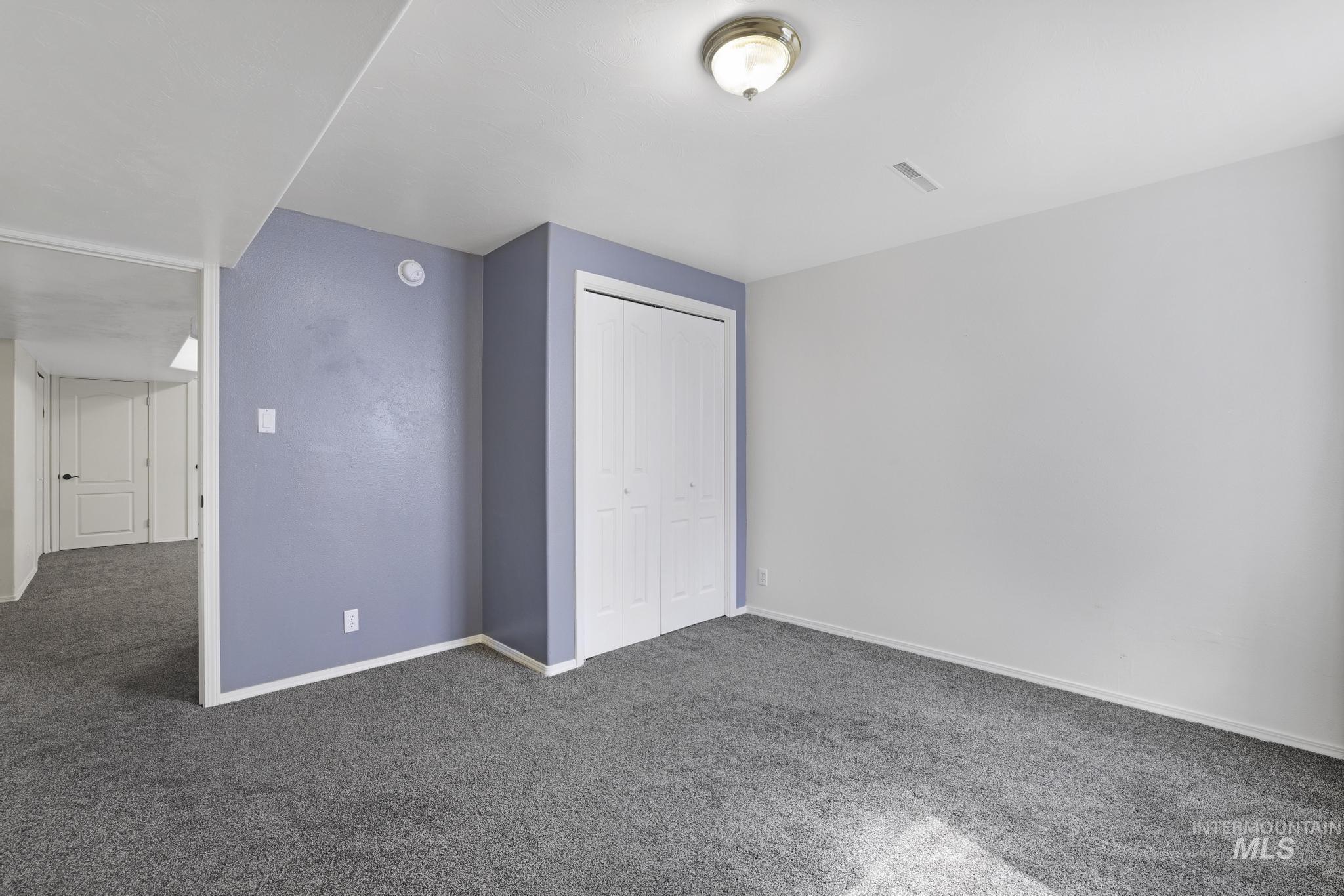 Unfurnished bedroom featuring carpet and a closet