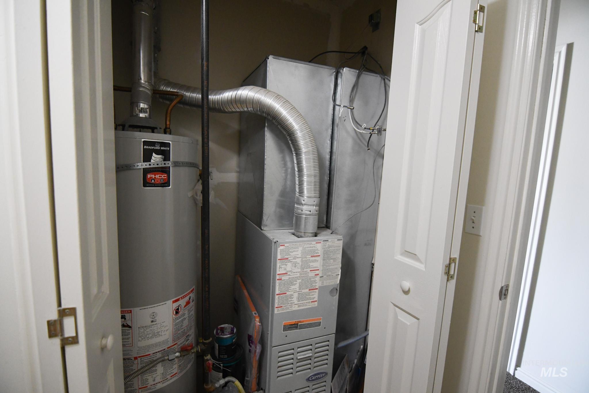Utilities featuring strapped water heater and heating unit