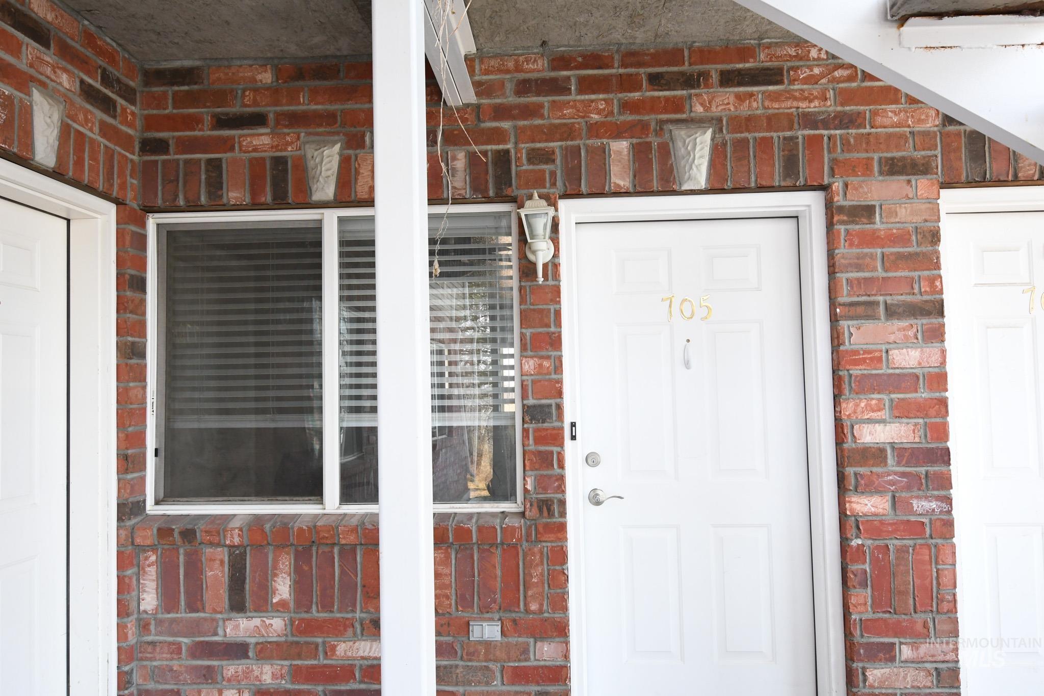 Entrance to property with brick siding