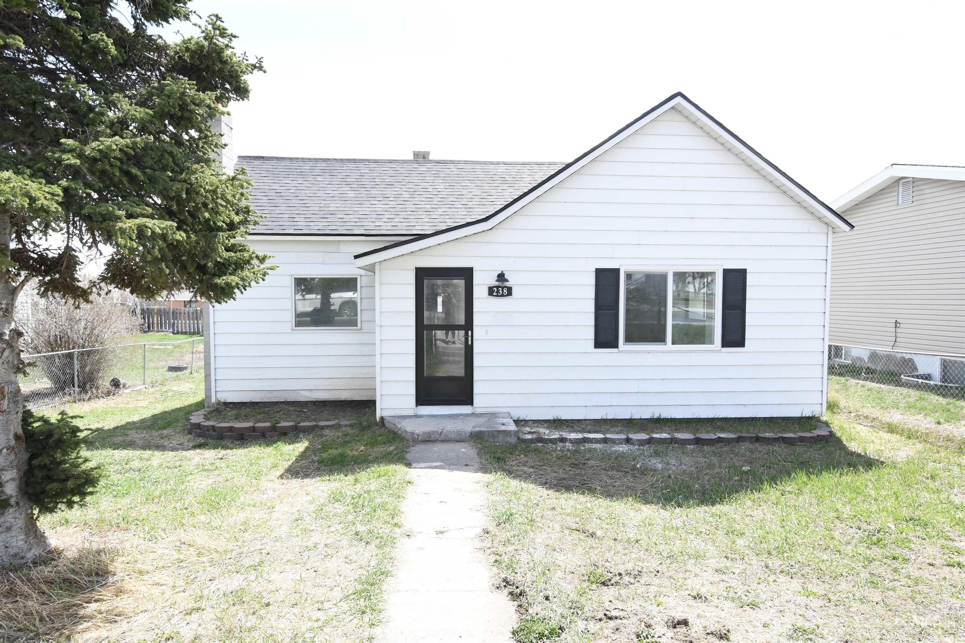 Bungalow-style home with a shingled roof