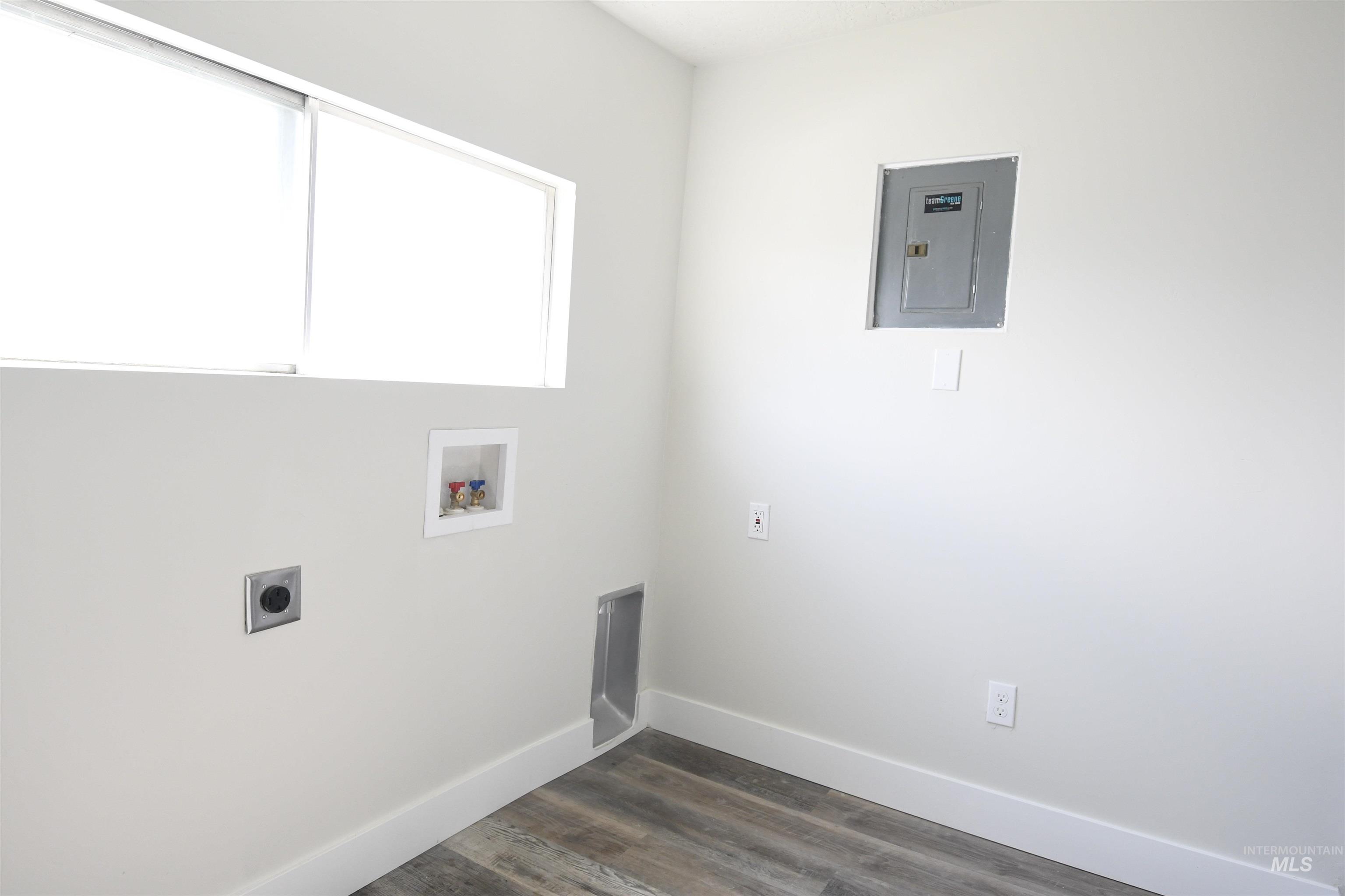 Laundry room featuring hookup for an electric dryer, dark wood-style floors, washer hookup, and electric panel