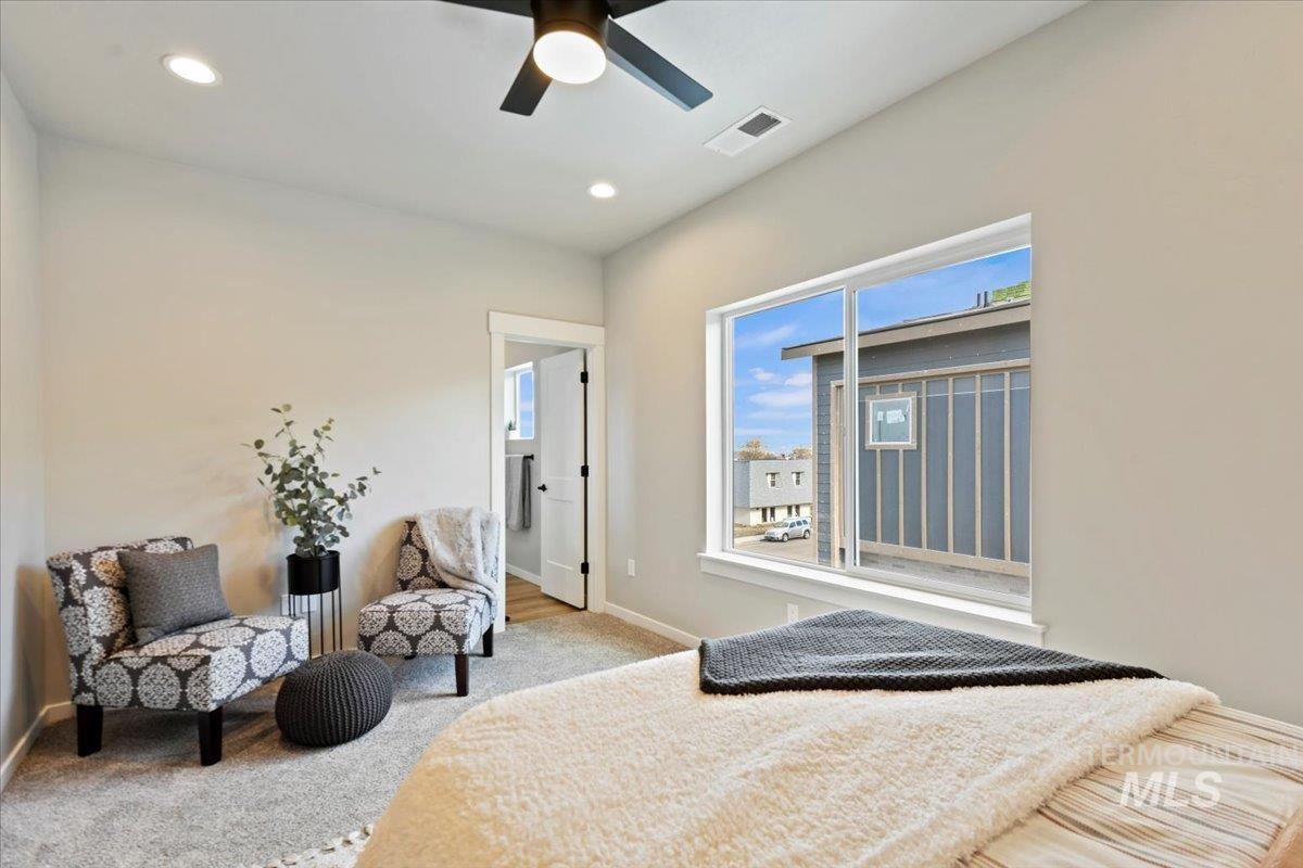 Carpeted bedroom with recessed lighting and a ceiling fan