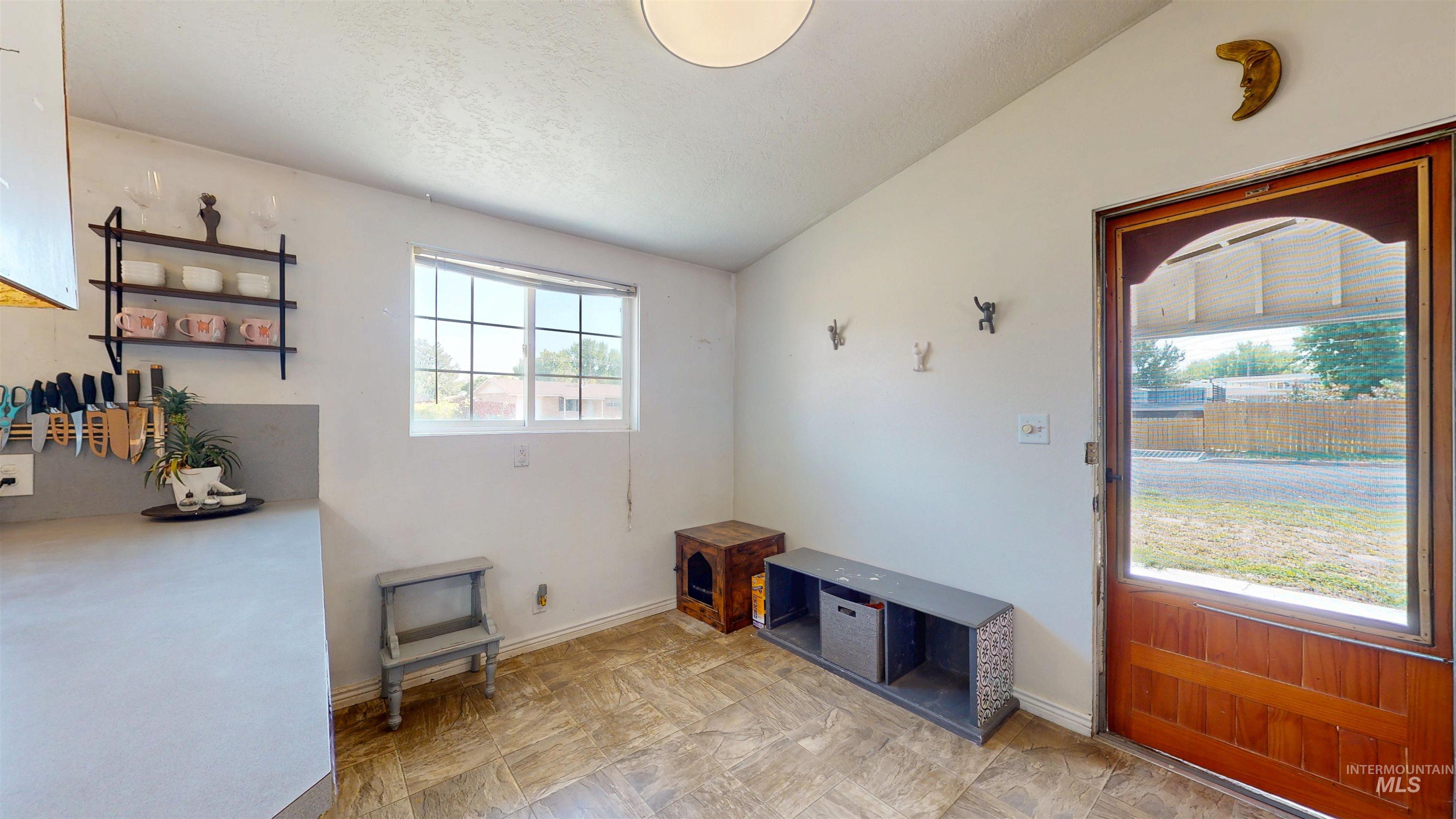Interior space with lofted ceiling and baseboards