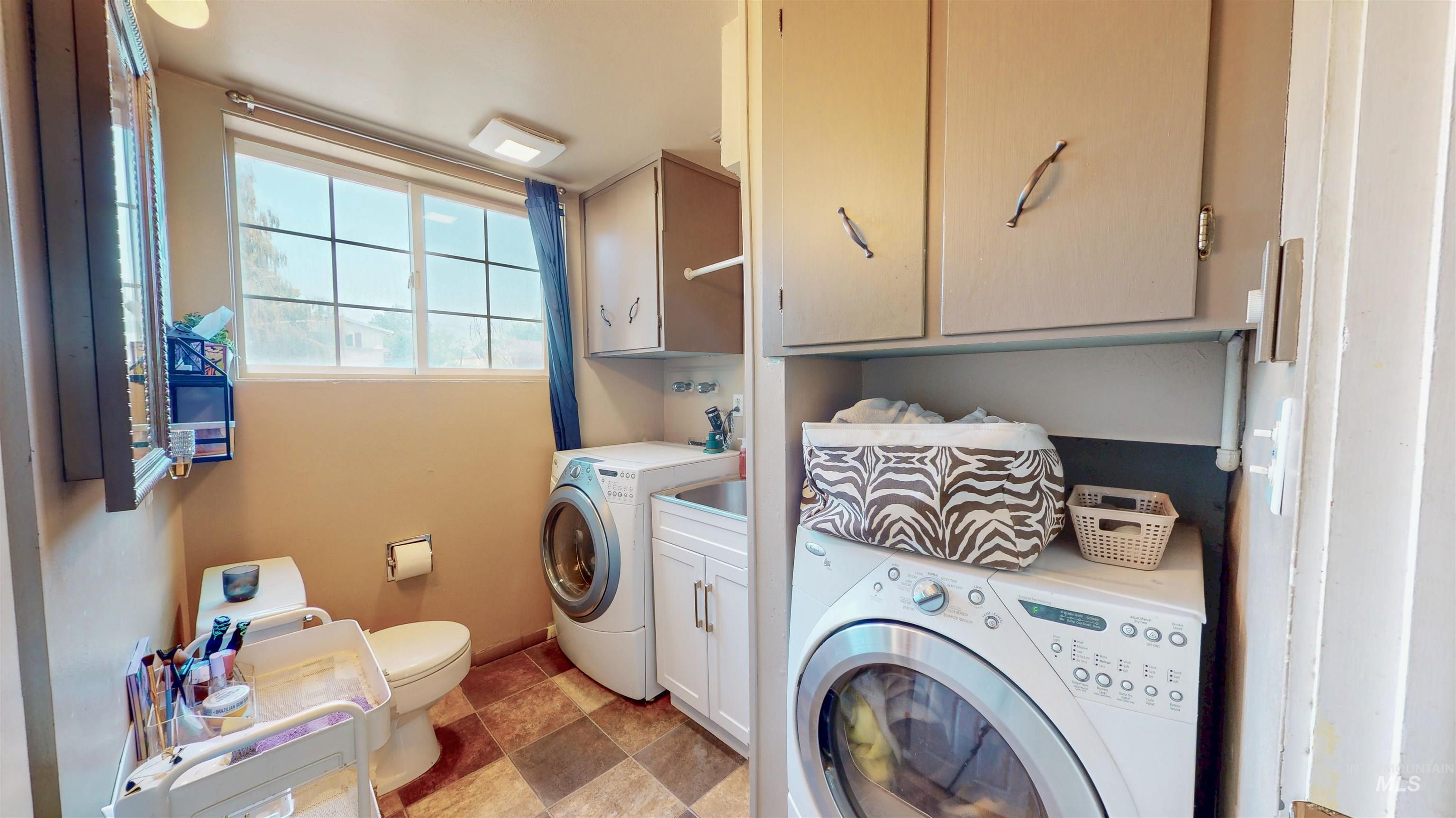 Laundry room featuring baseboards