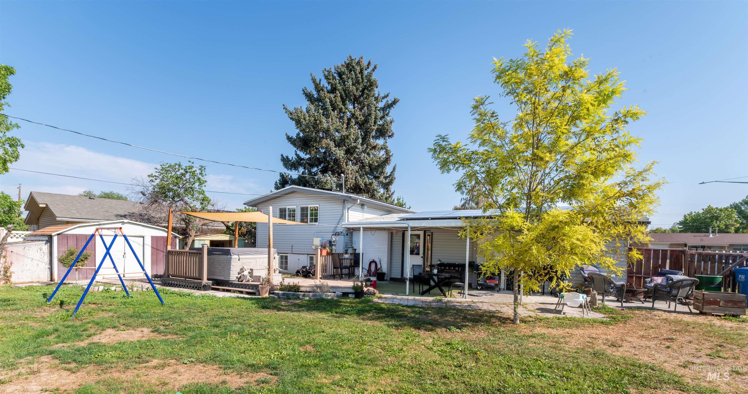 Back of property featuring a gazebo, a shed, a patio, and a fenced backyard