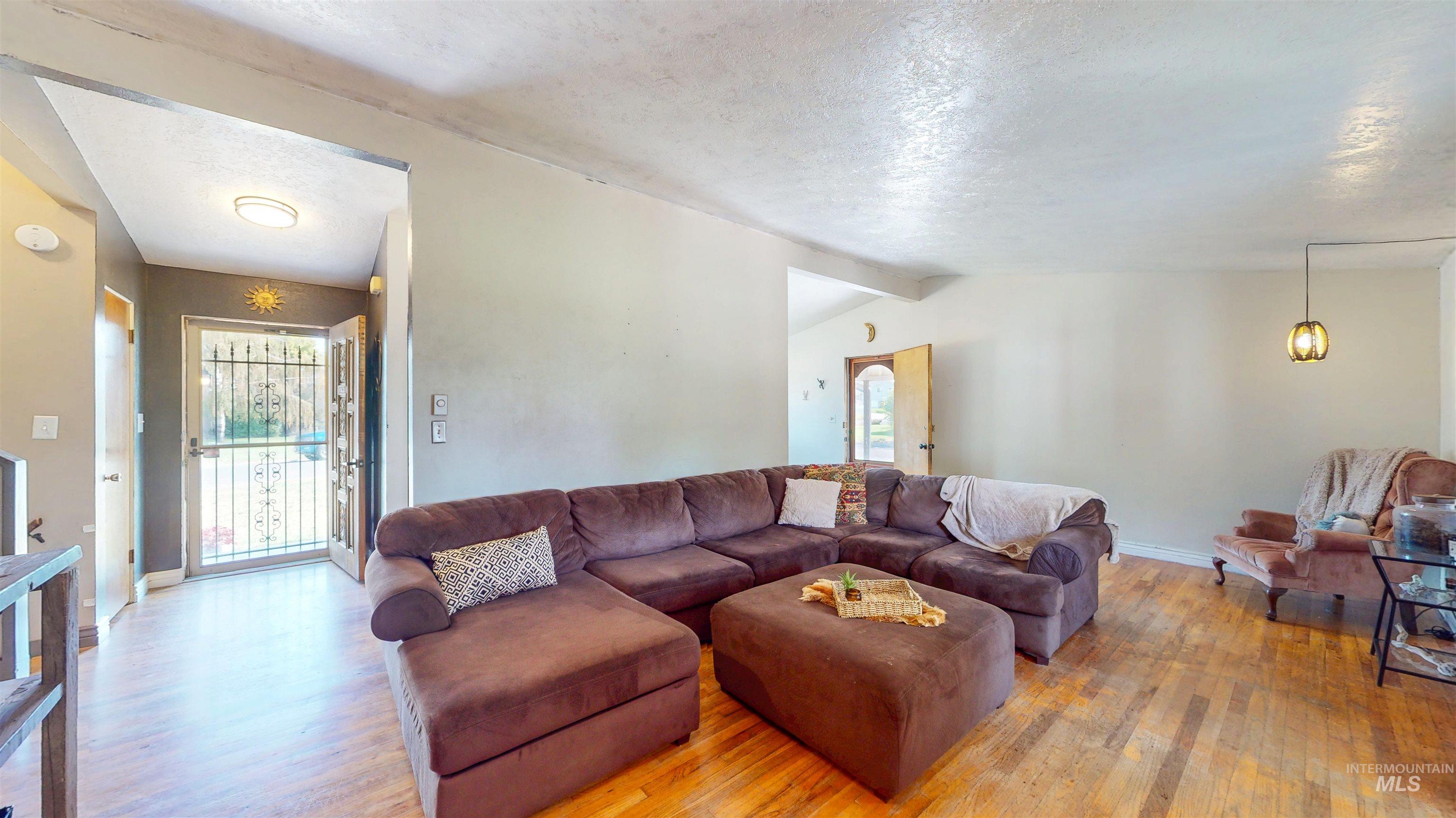 Living room with wood finished floors and a textured ceiling