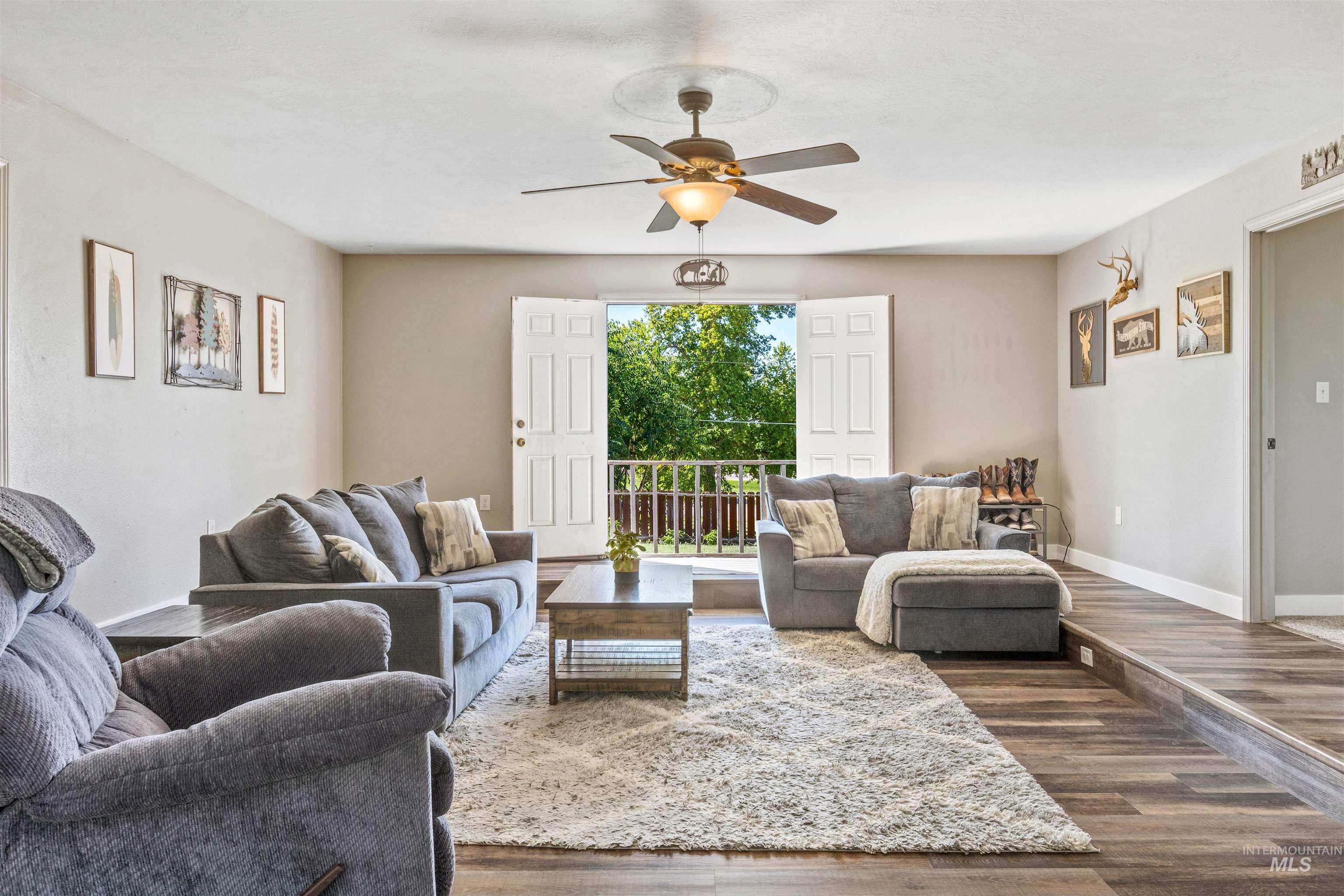 Living room with wood finished floors and ceiling fan