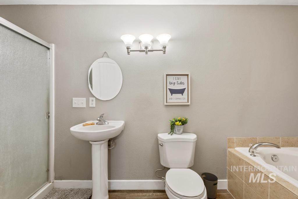 Full bath with a bath and a stall shower