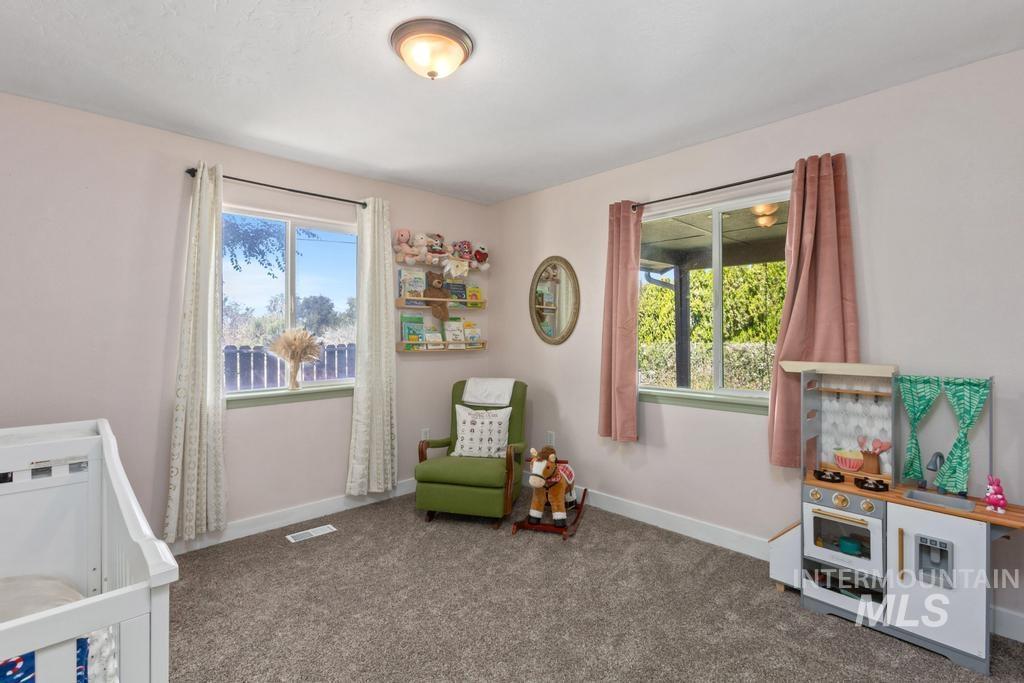 Bedroom featuring baseboards and carpet floors