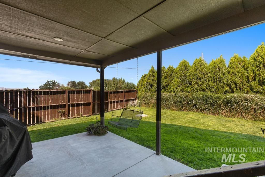 View of patio with a grill