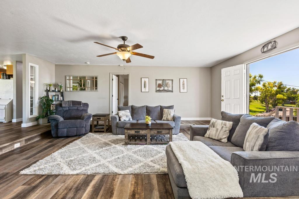 Living area featuring wood finished floors and ceiling fan