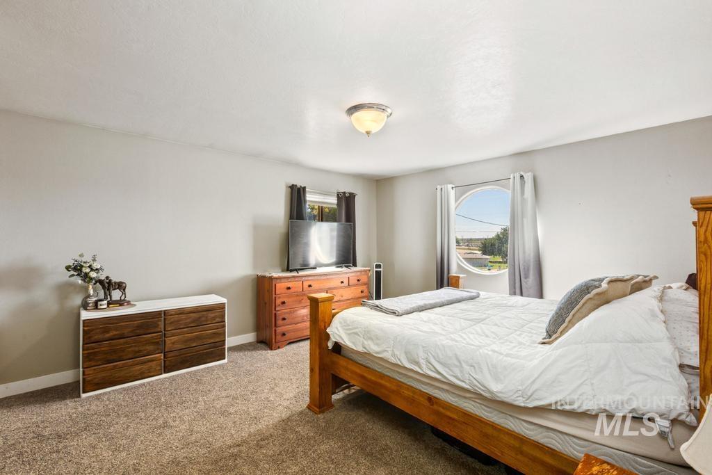Bedroom featuring carpet flooring and baseboards