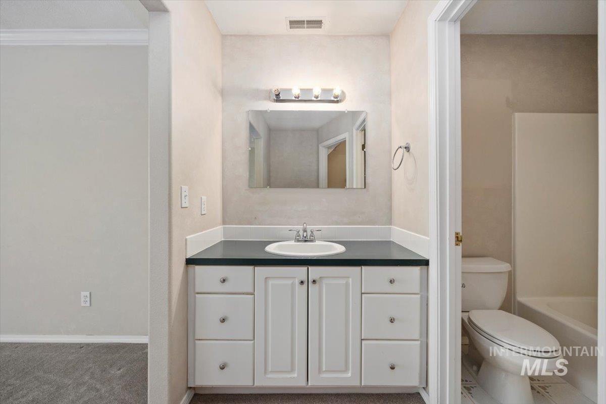 Full bath featuring vanity and bathing tub / shower combination