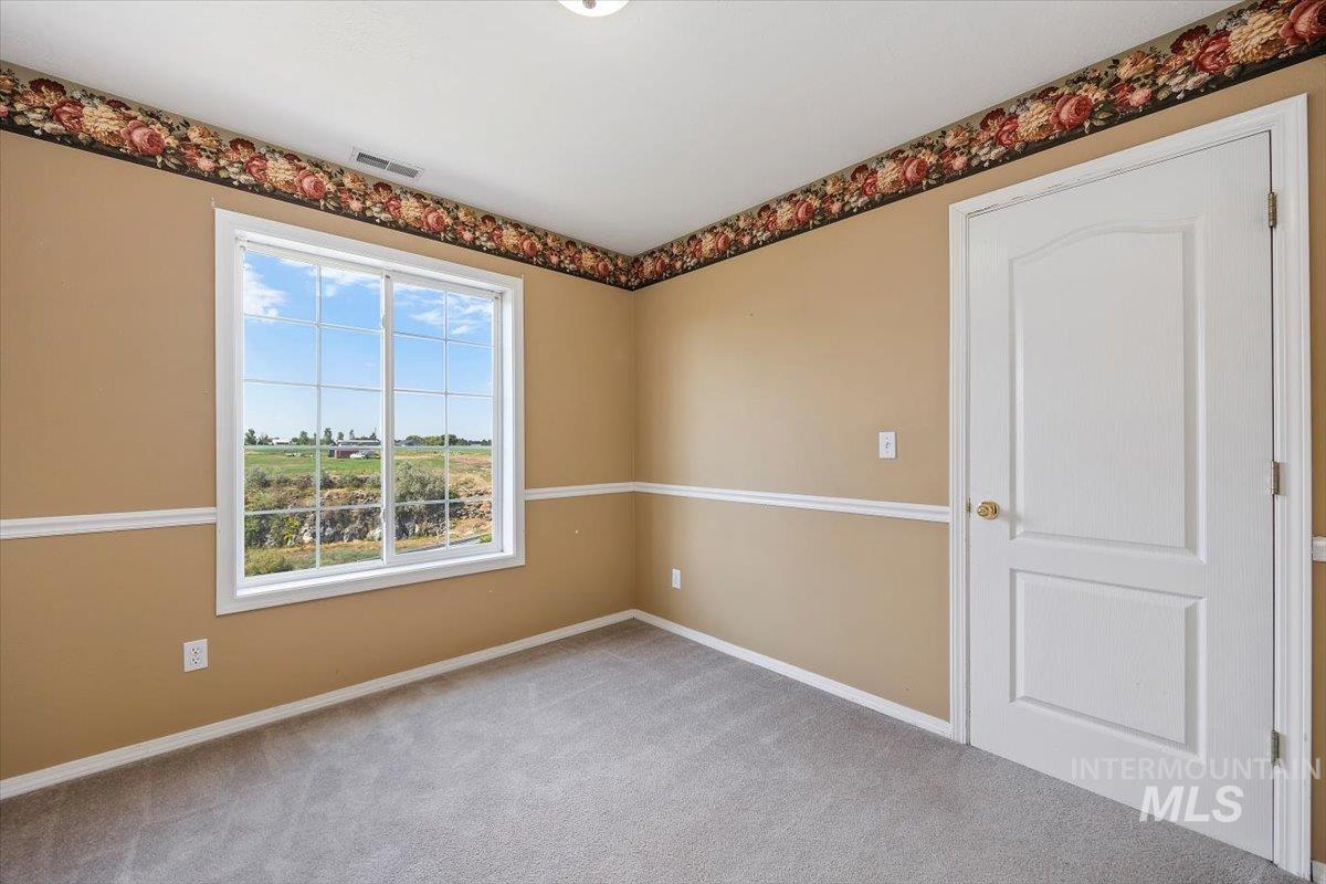 Unfurnished room featuring carpet flooring and baseboards