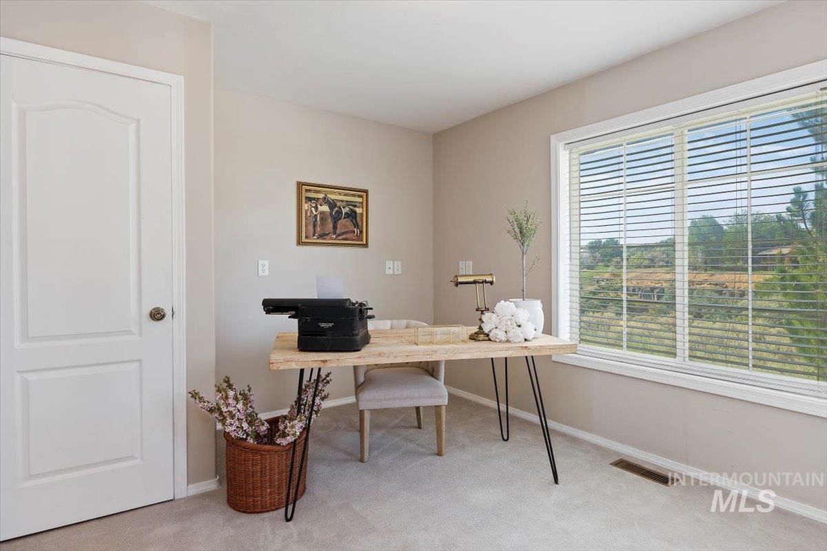 Home office featuring carpet flooring and baseboards