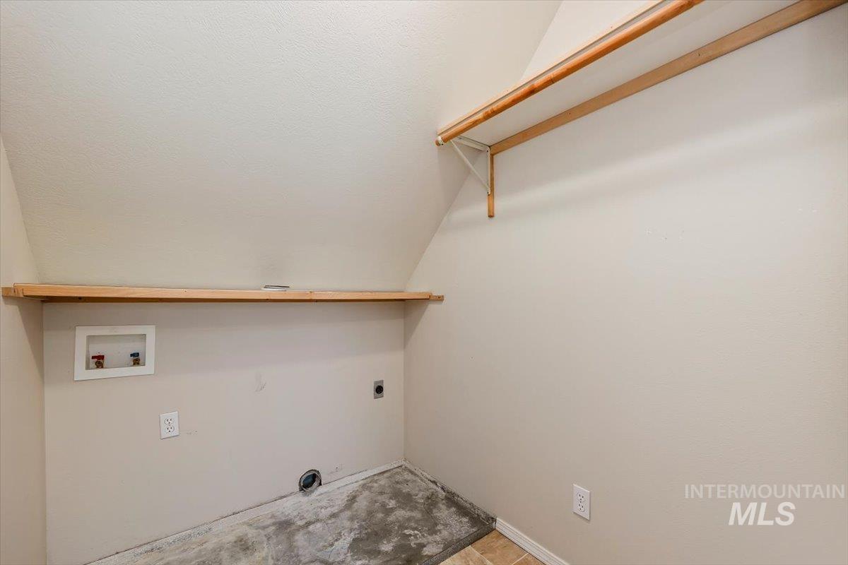 Laundry area featuring electric dryer hookup, washer hookup, and a textured ceiling