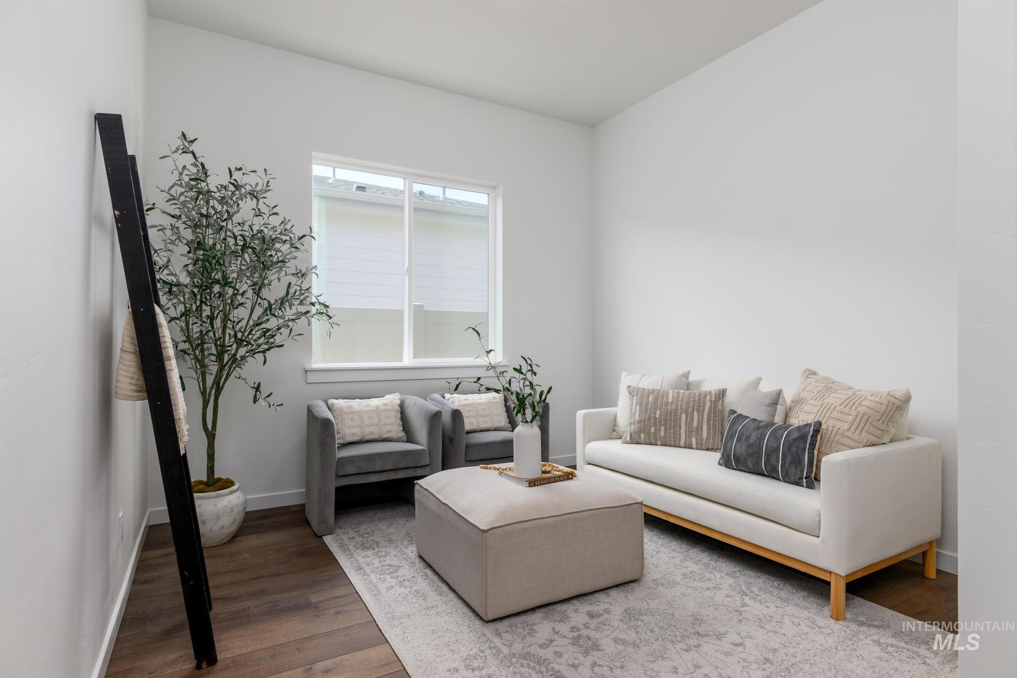 Sitting room featuring wood finished floors and baseboards