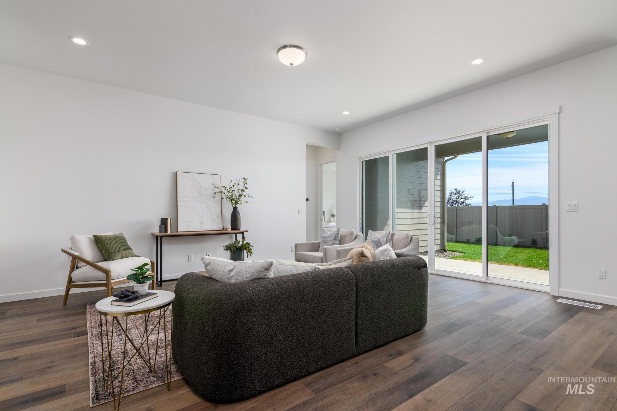 Living room featuring recessed lighting and dark wood-style floors