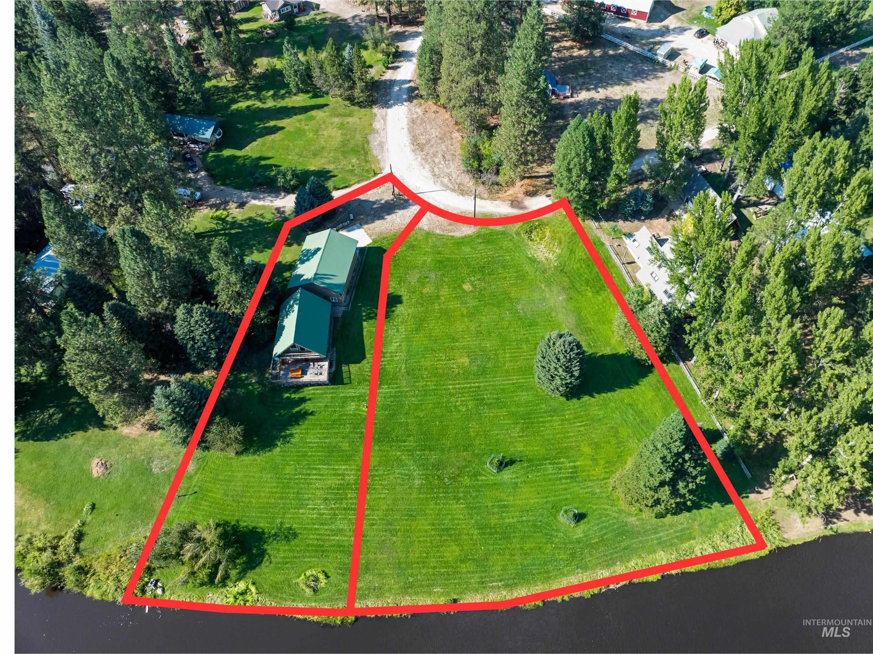 Aerial view of property and surrounding area with property parcel outlined