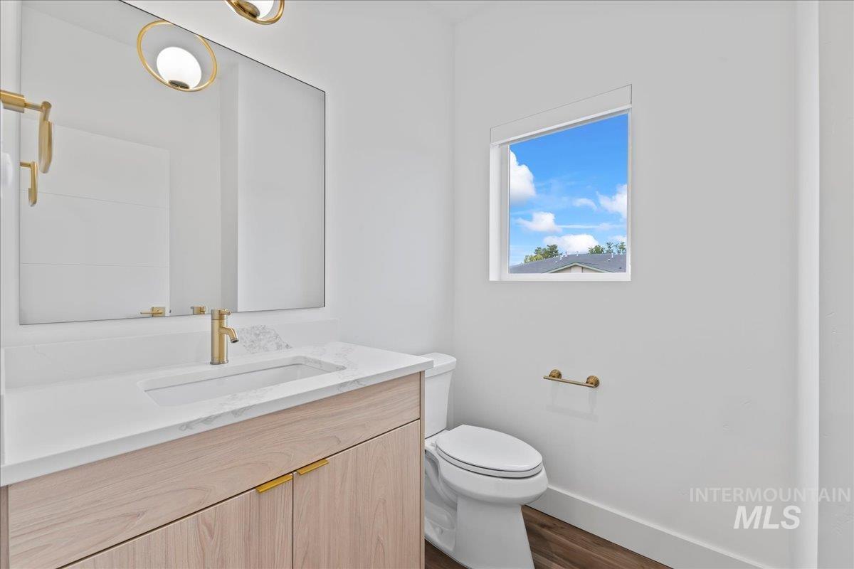 Bathroom featuring vanity and dark wood-style floors