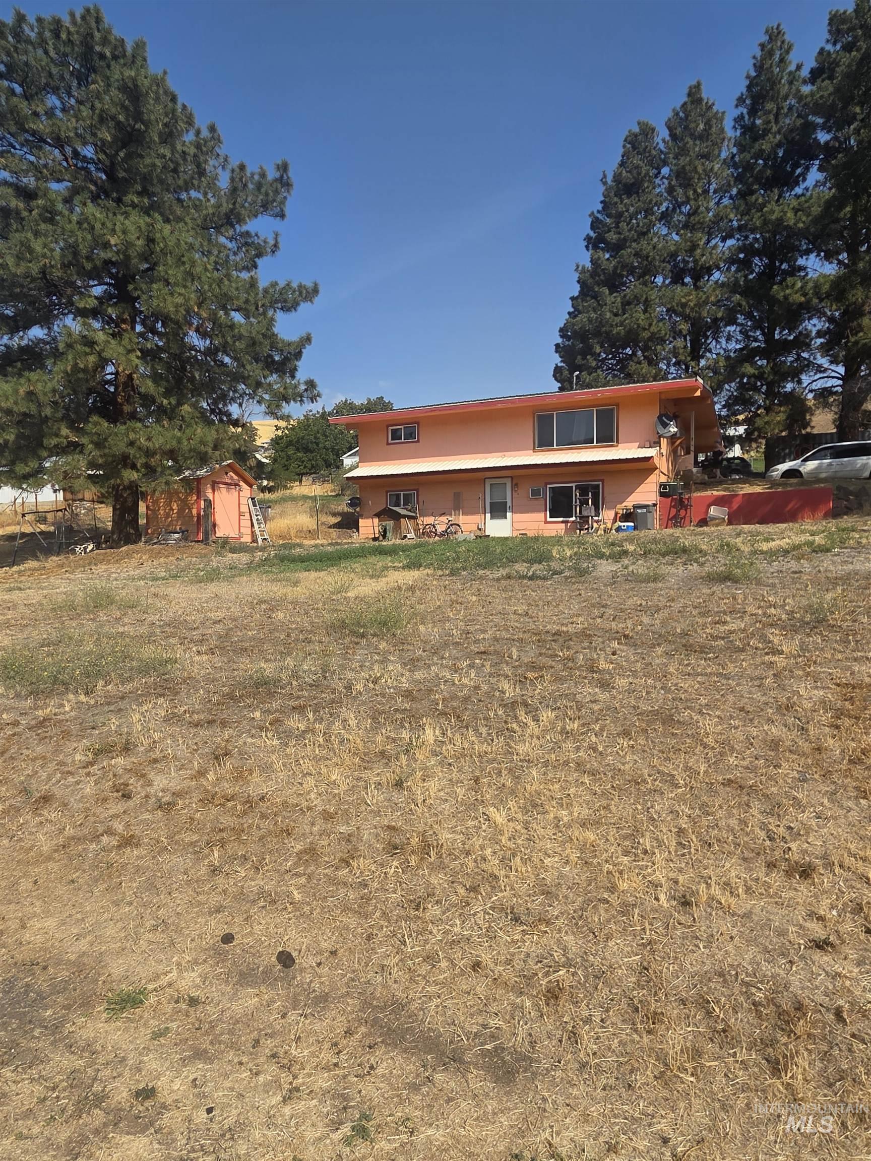 View of front facade with a storage shed and a front yard