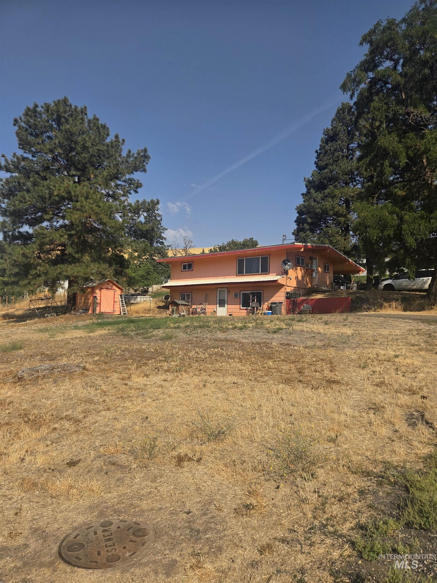 Rear view of property with a storage shed