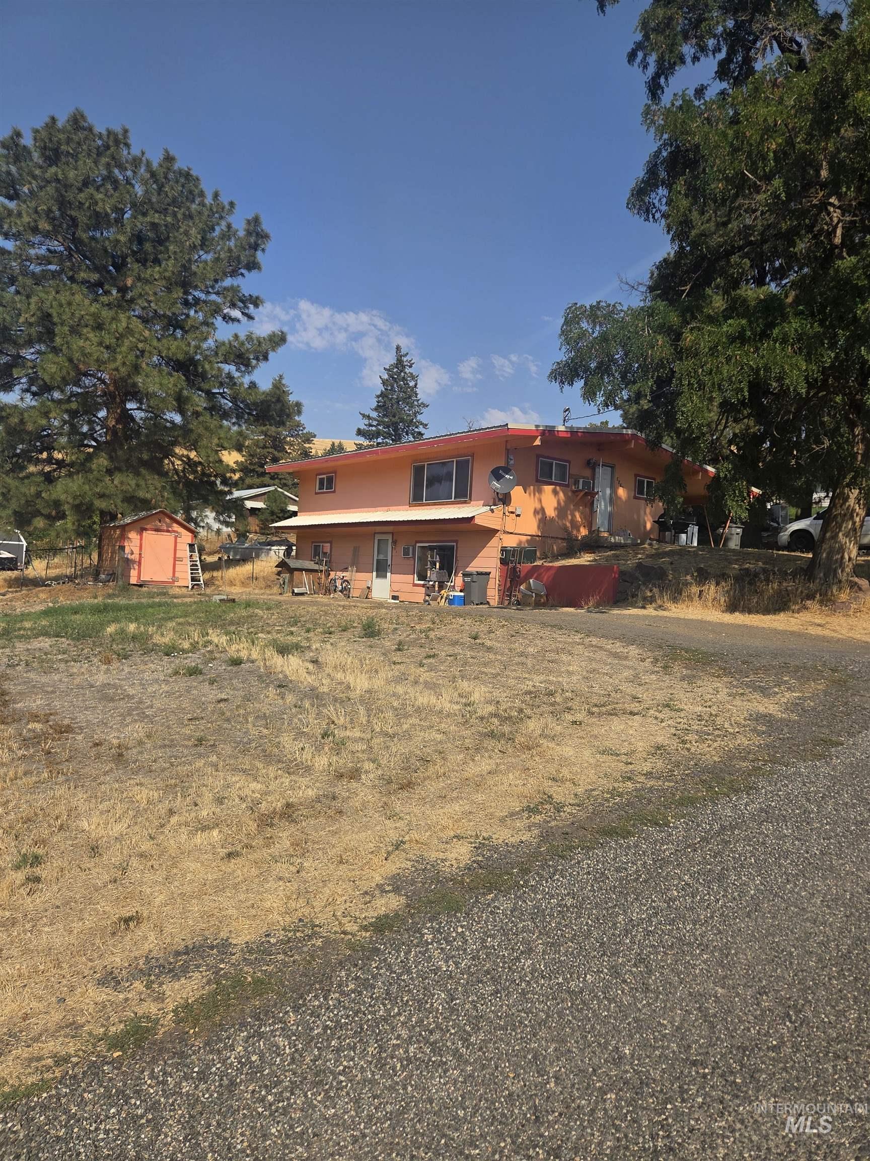 View of front of property featuring a storage unit