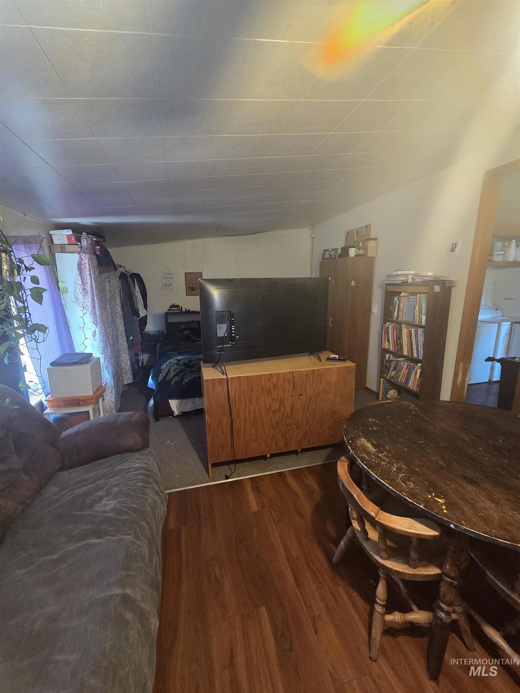 Living area featuring wood finished floors and washer / clothes dryer
