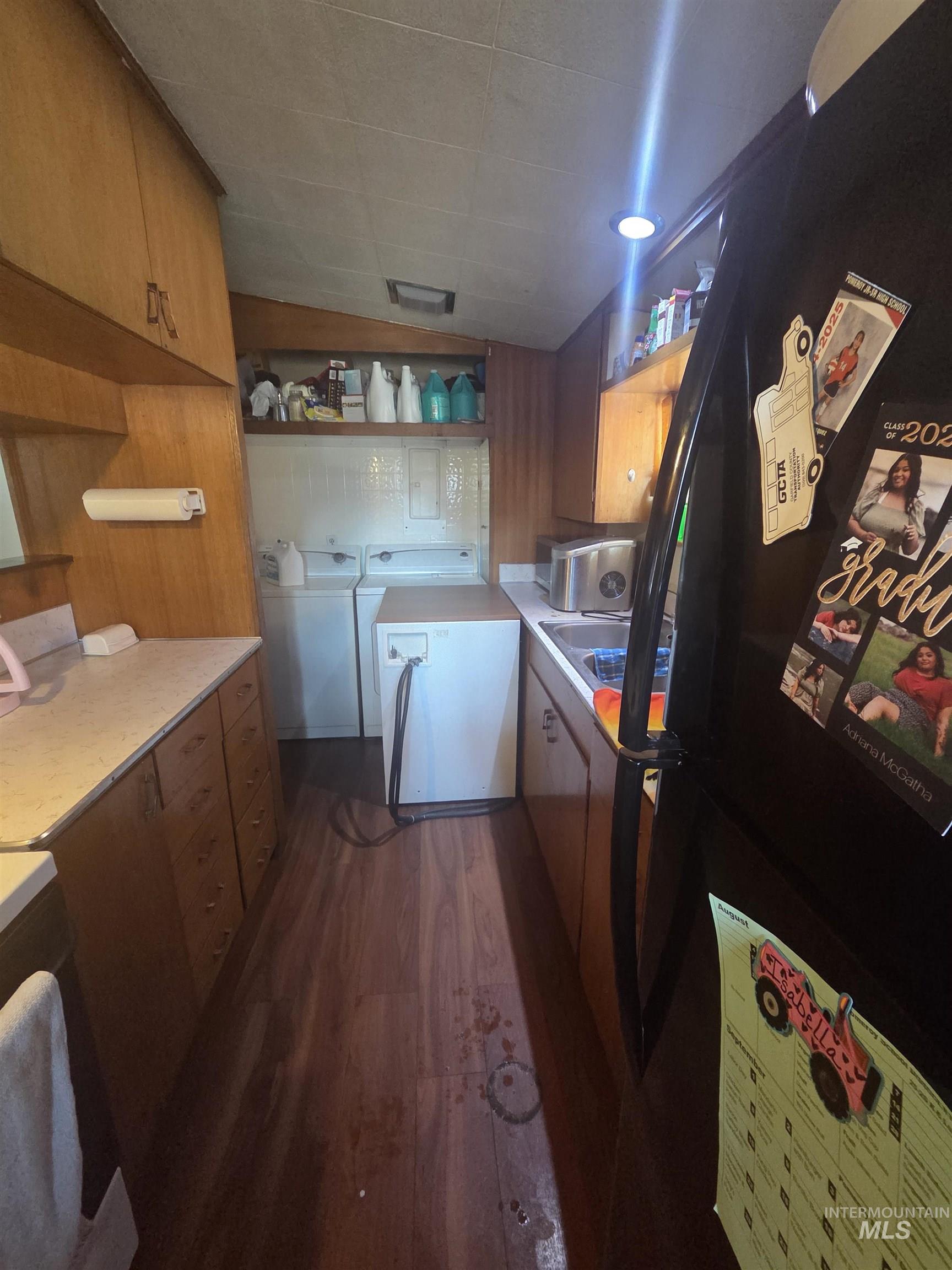 Kitchen featuring open shelves, freestanding refrigerator, and dark wood-type flooring
